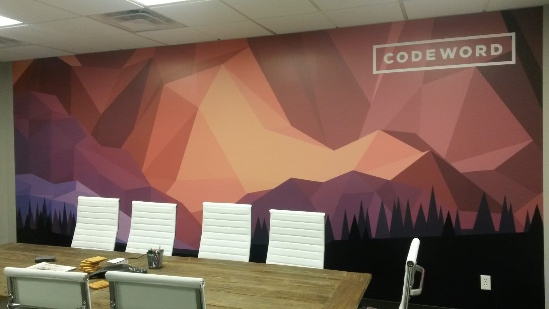 Office with geometric mountain mural as a backdrop