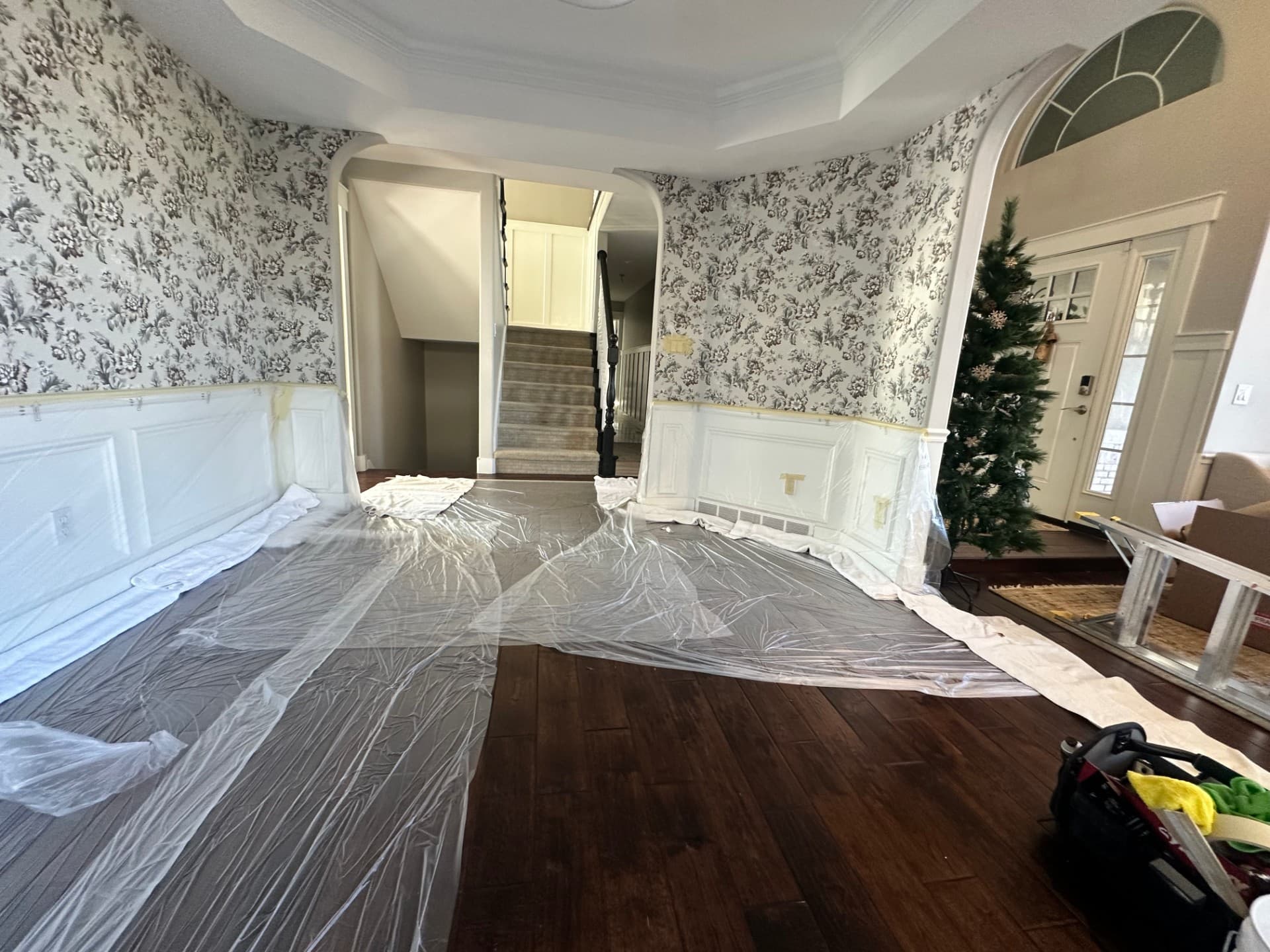 Foyer prepped with protective plastic sheeting before wallpaper install