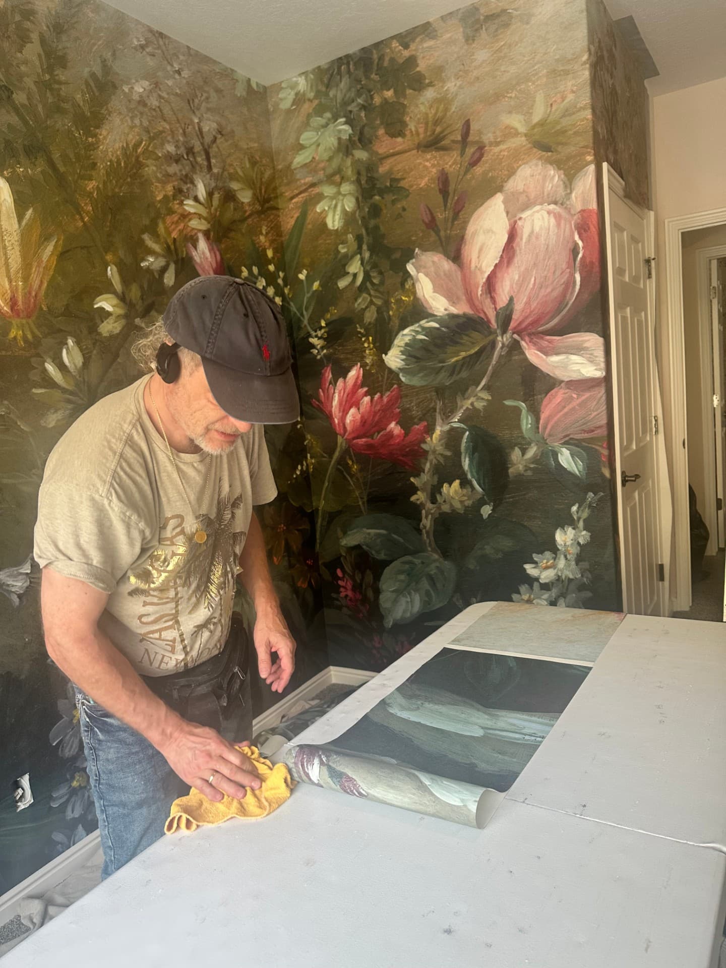 Installer cleaning framed floral artwork after install