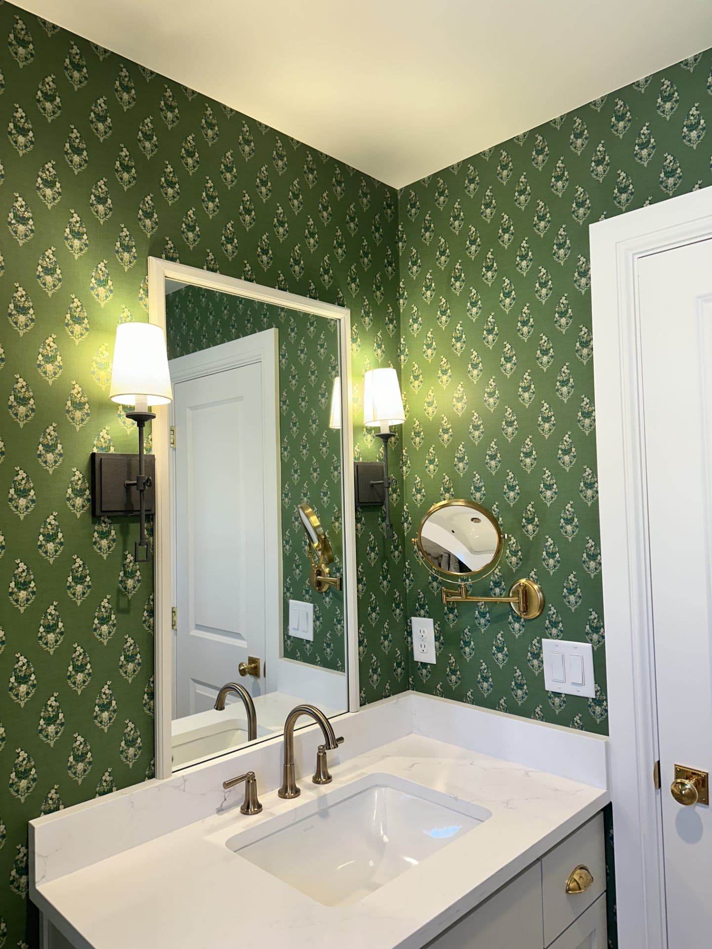 Bathroom with green damask wallpaper