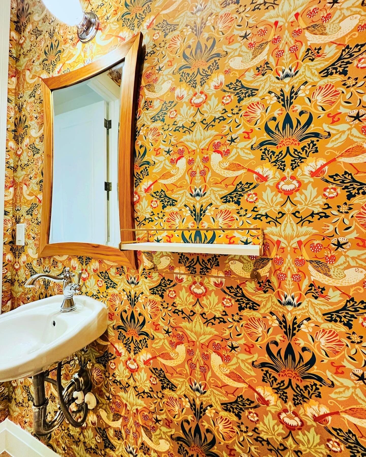 Powder room with ornate gold damask wallpaper