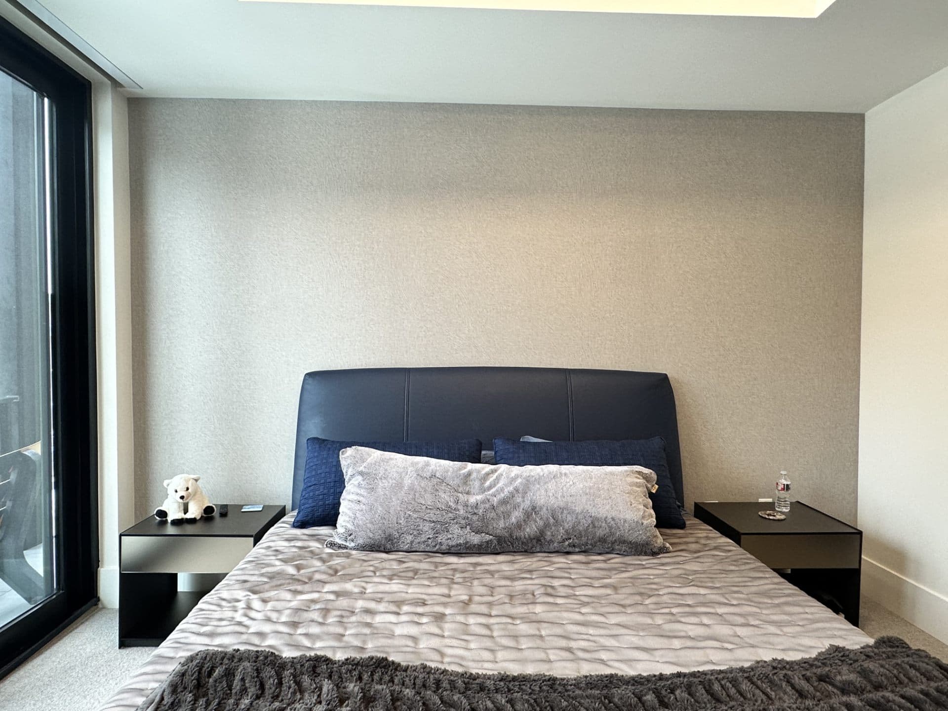 Modern bedroom with minimal grey wallpaper