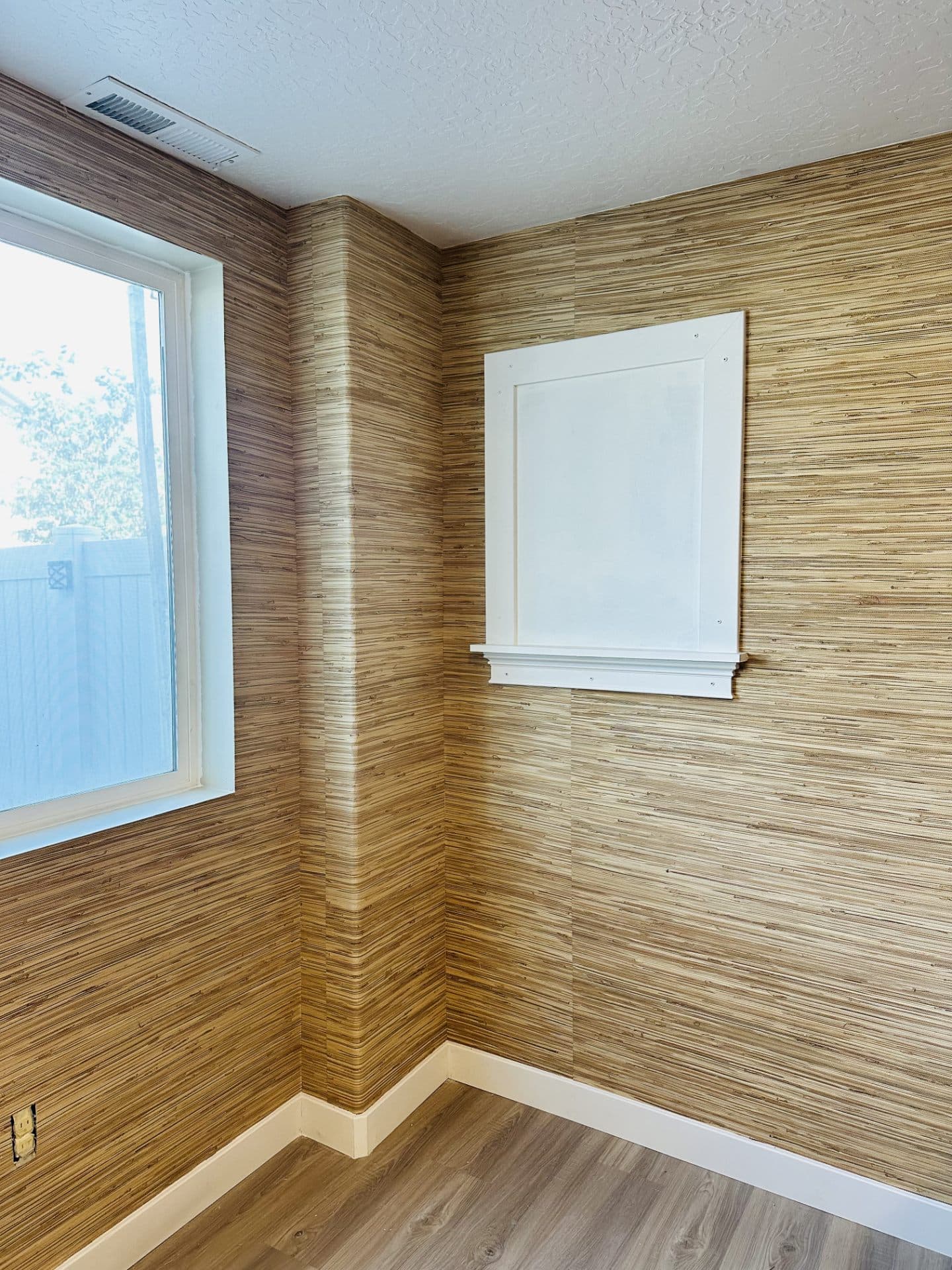 Wood wall corner with wallpaper cut clean to window trim