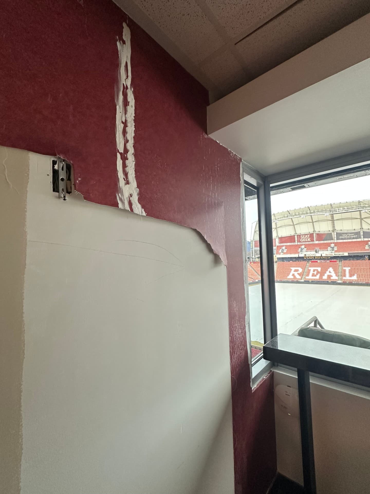 Peeling wallpaper and wall damage in a commercial interior — the starting condition before substrate prep