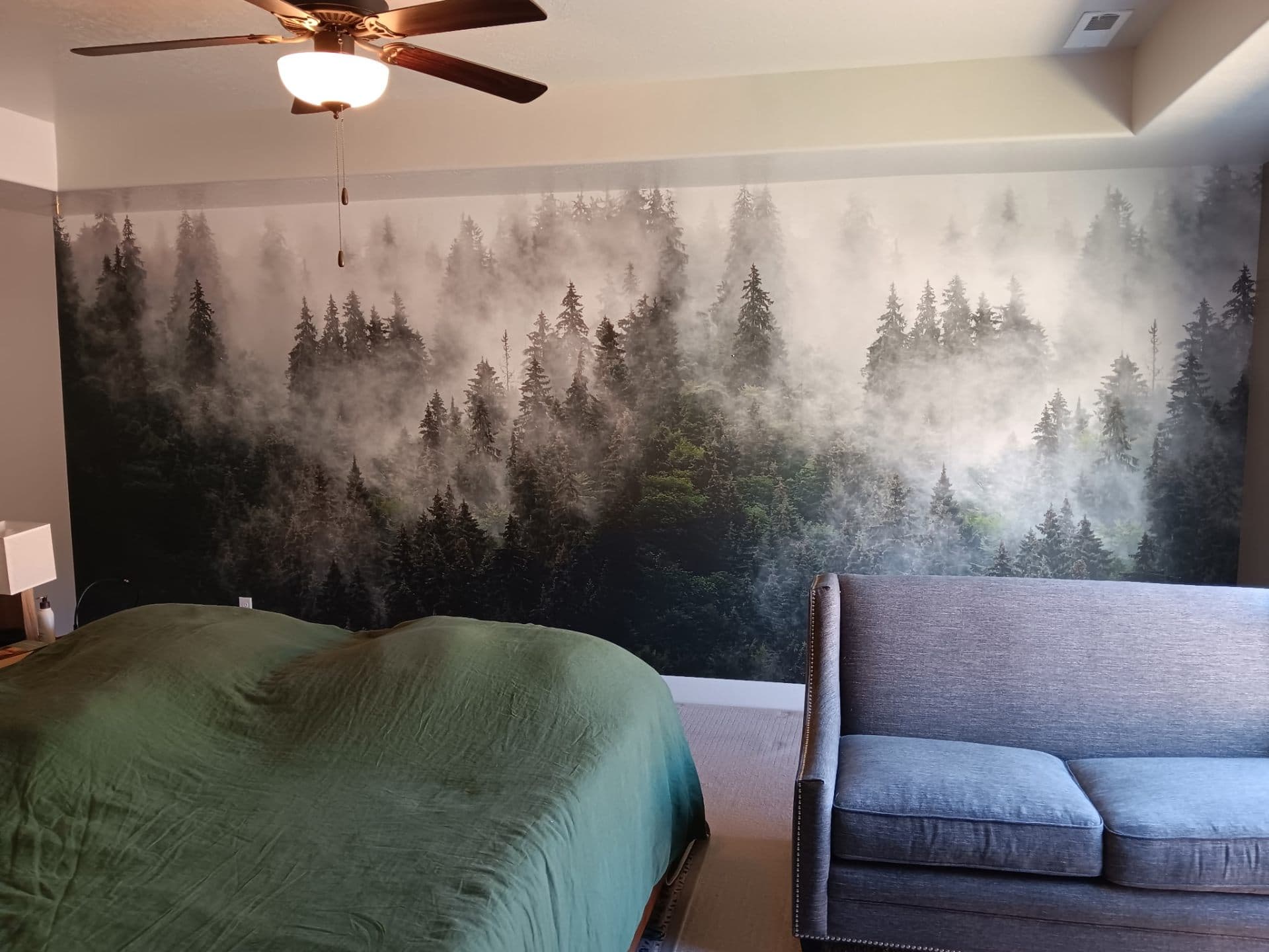 Bedroom with misty forest mural across the headboard wall