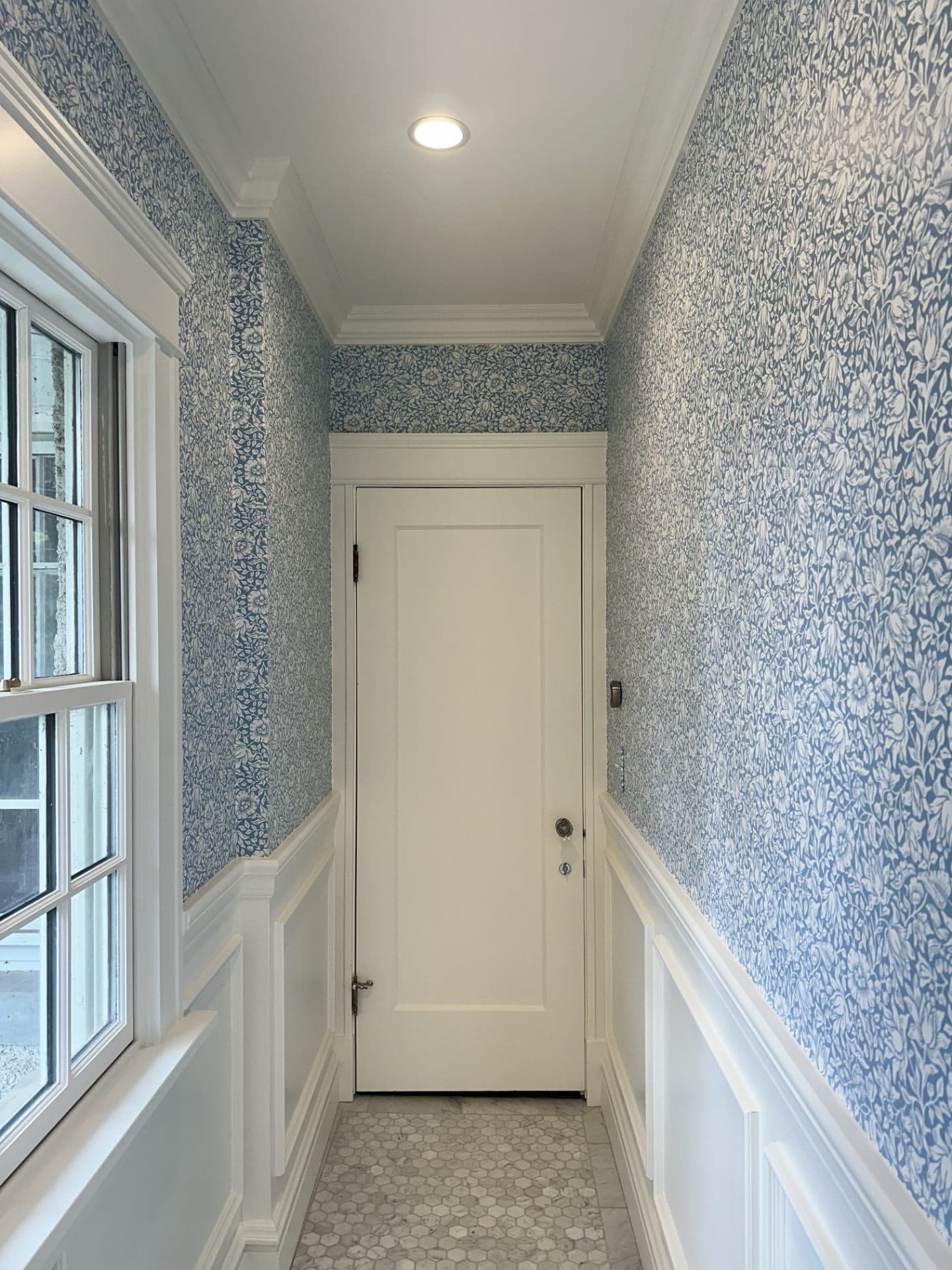 Hallway with classic damask wallpaper pattern
