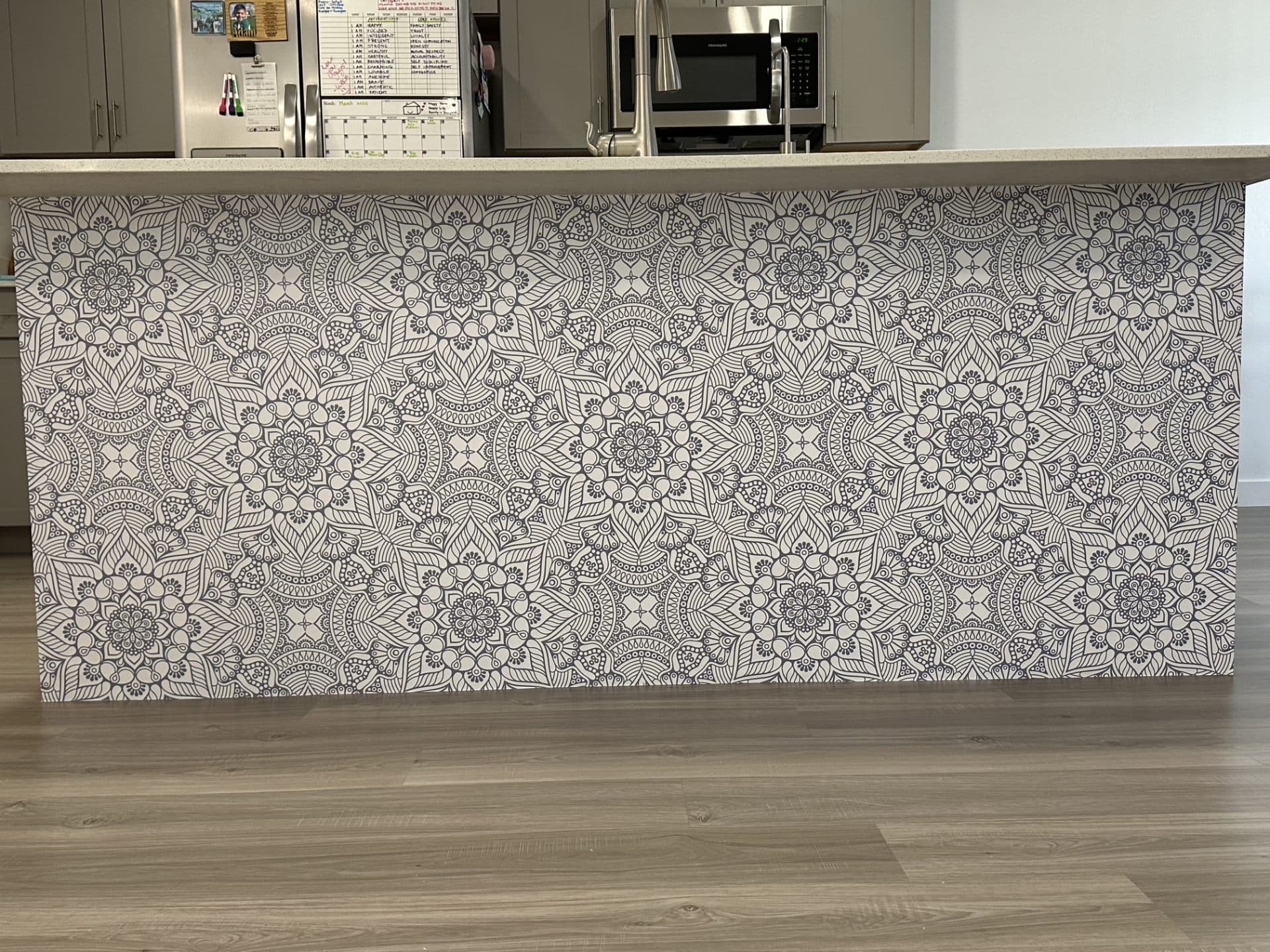 Kitchen with patterned tile and accent wall behind the island