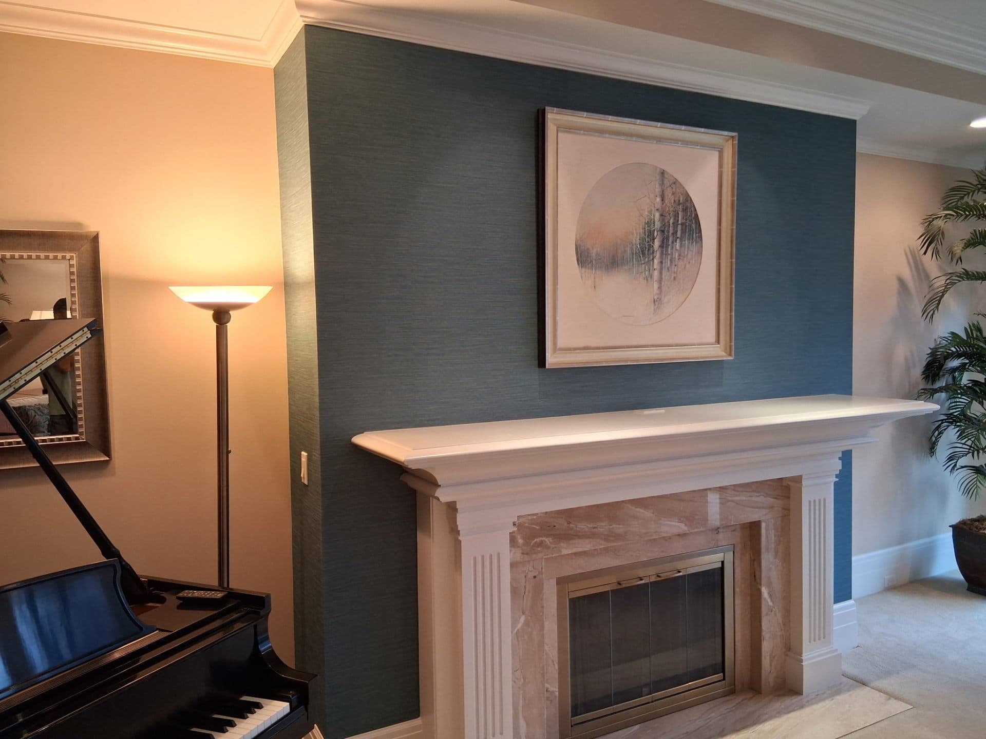 Modern living room with teal accent wall behind the fireplace