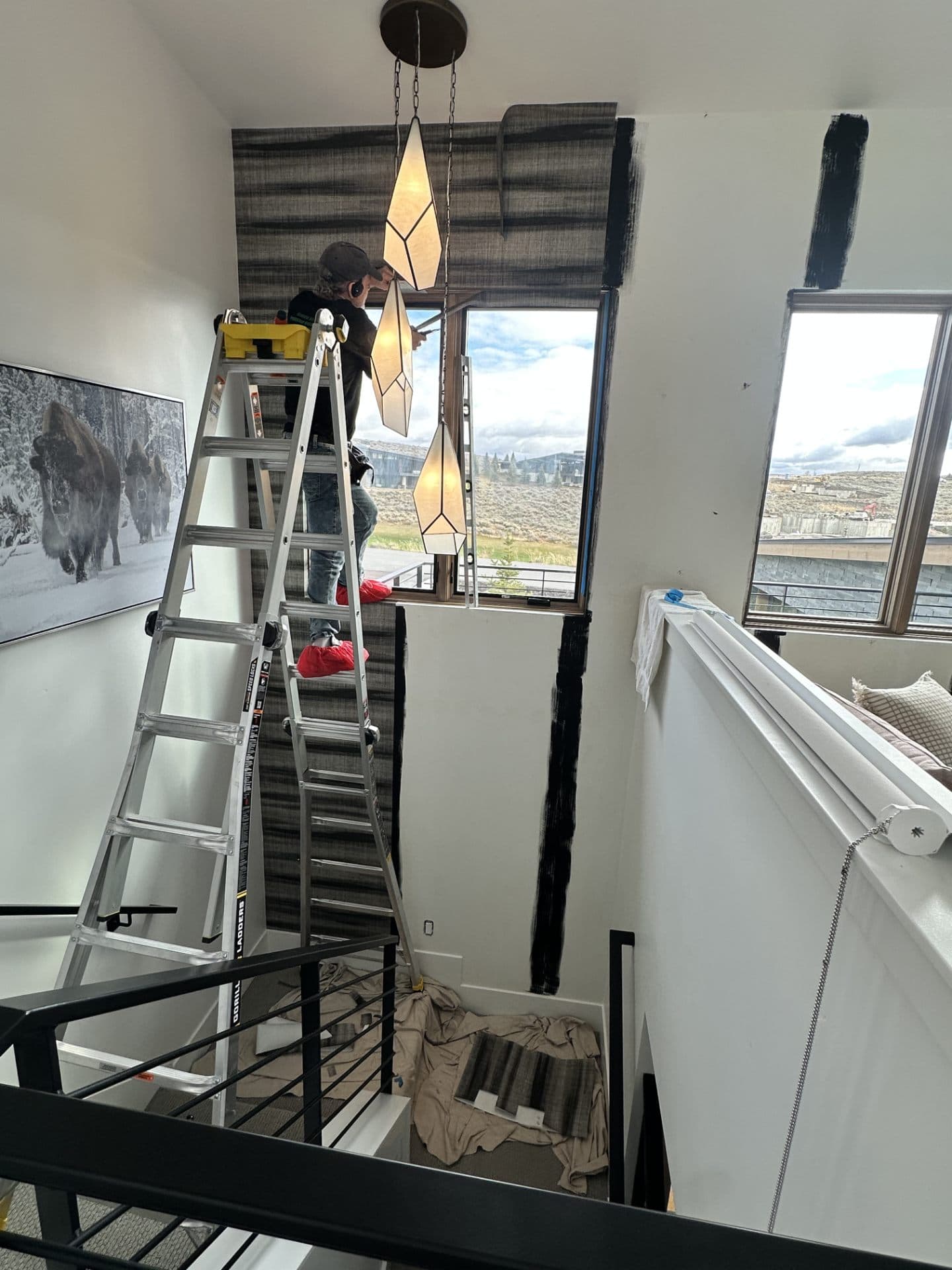 Robert installing a pendant light fixture