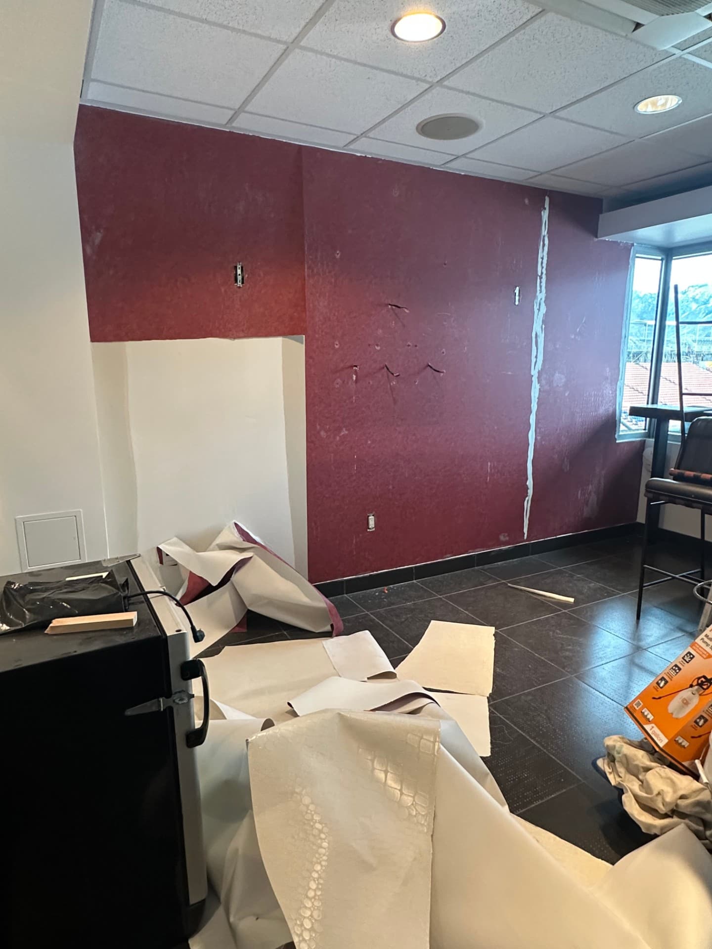 Burgundy commercial walls mid-renovation, before the install